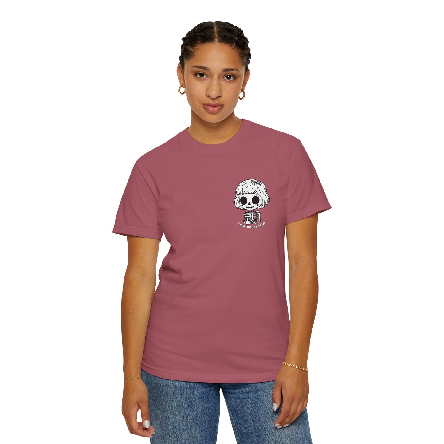 Alternate view of a woman wearing a Crimson colored t-shirt with a design of a skeleton girl holding a cup of coffee printed on the front. Written underneath the design is the text, "I'm dying for coffee". The design is placed on the left chest area of the t-shirt.