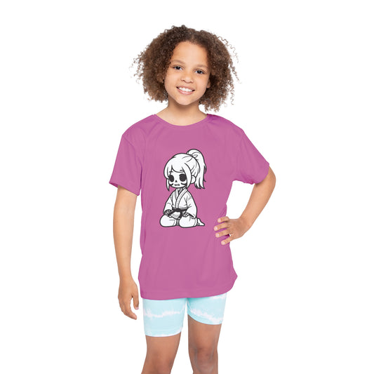 Front view of a girl wearing a light pink, polyester kids t-shirt, with a design of a skeleton girl wearing a jiu jitsu gi and black belt on the front.