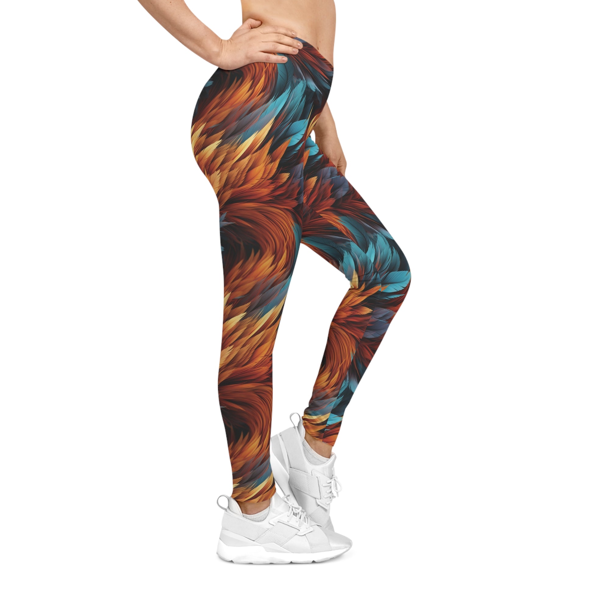 Right side view of a woman wearing aqua and orange colored, feather print low rise leggings.