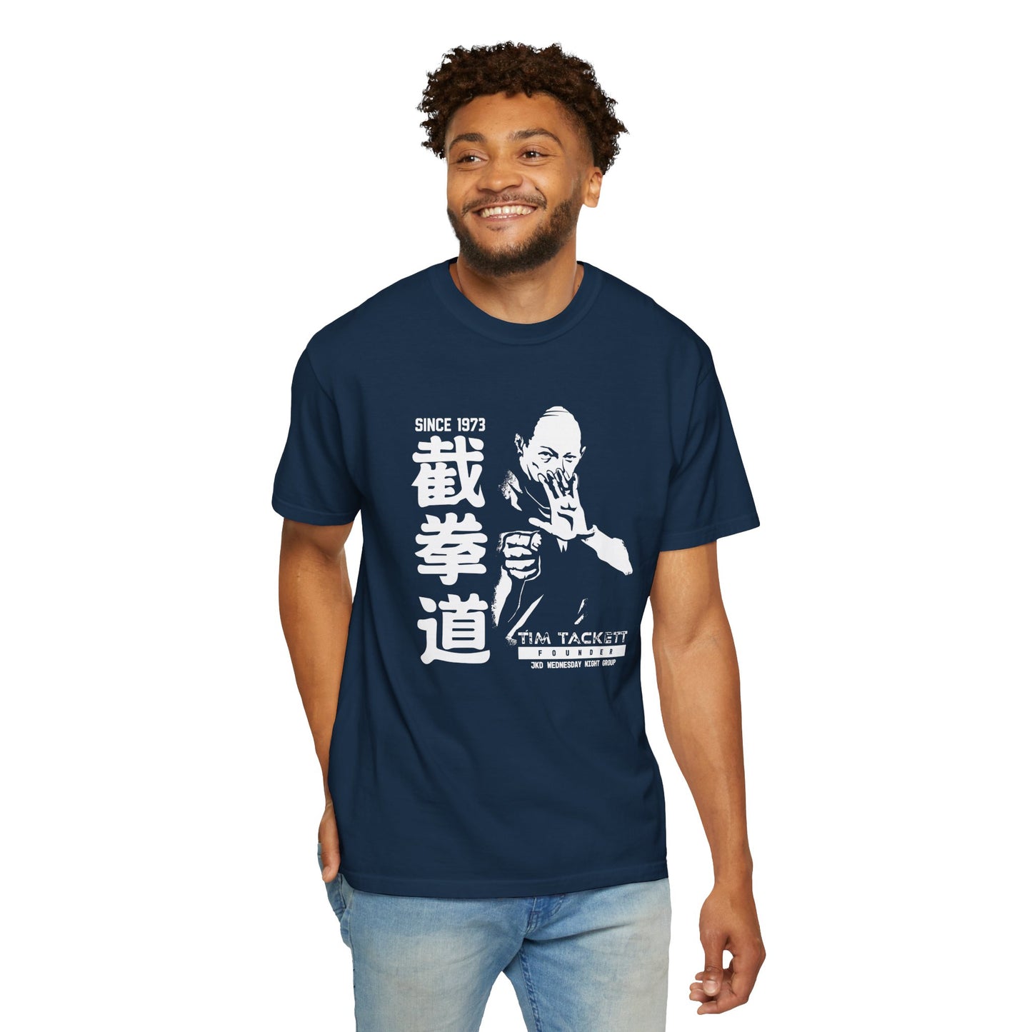 Man wearing a True Navy colored, cotton t-shirt with an illustration of martial arts instructor Tim Tackett on the front. The text surrounding the design reads "Jeet Kune Do since 1973".