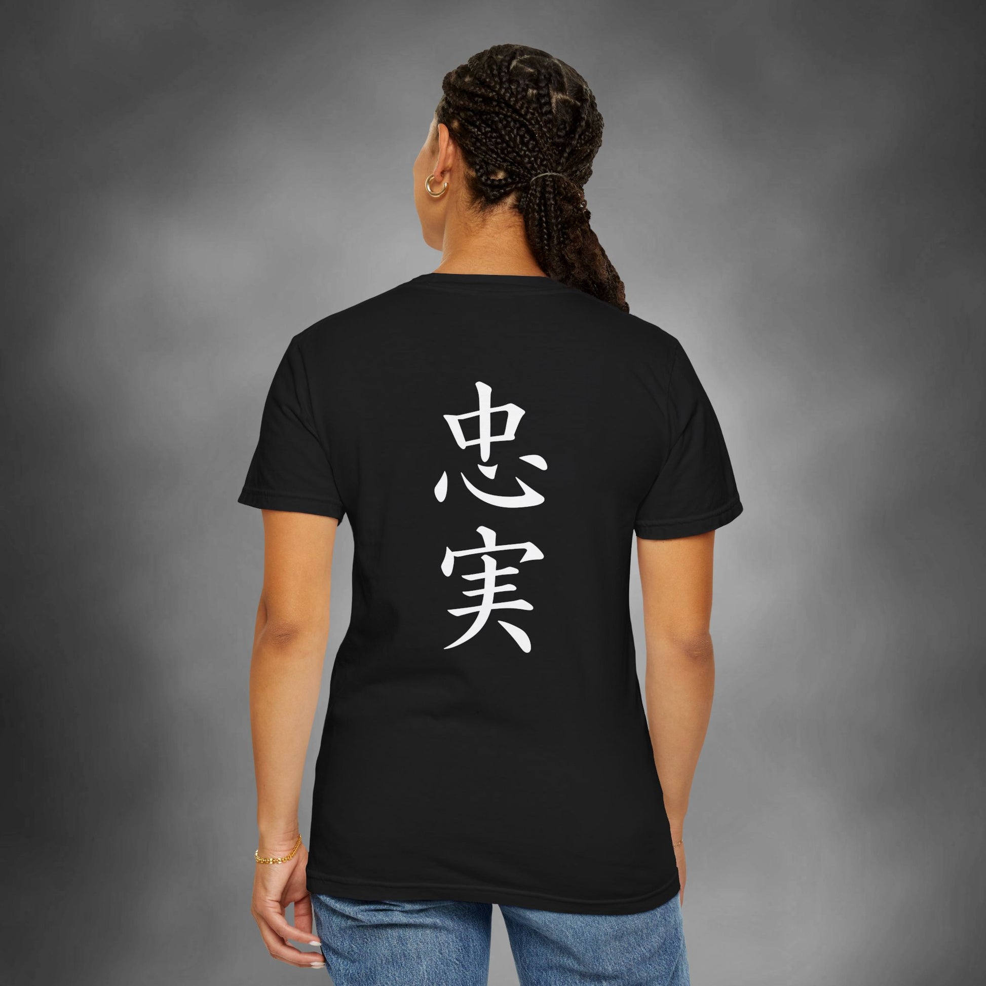 Back view of a woman wearing a black cotton t-shirt with the kanji for "Loyal" printed vertically down the middle.