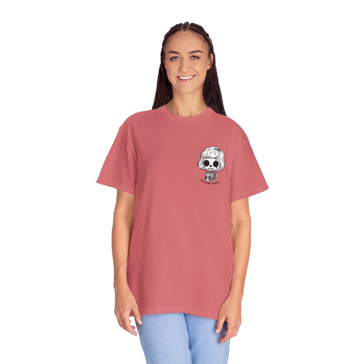 Alternate view of a tall, thin woman wearing a Watermelon colored t-shirt with a design of a skeleton girl holding a cup of coffee printed on the front. Written underneath the design is the text, "I'm dying for coffee". The design is placed on the left chest area of the t-shirt.