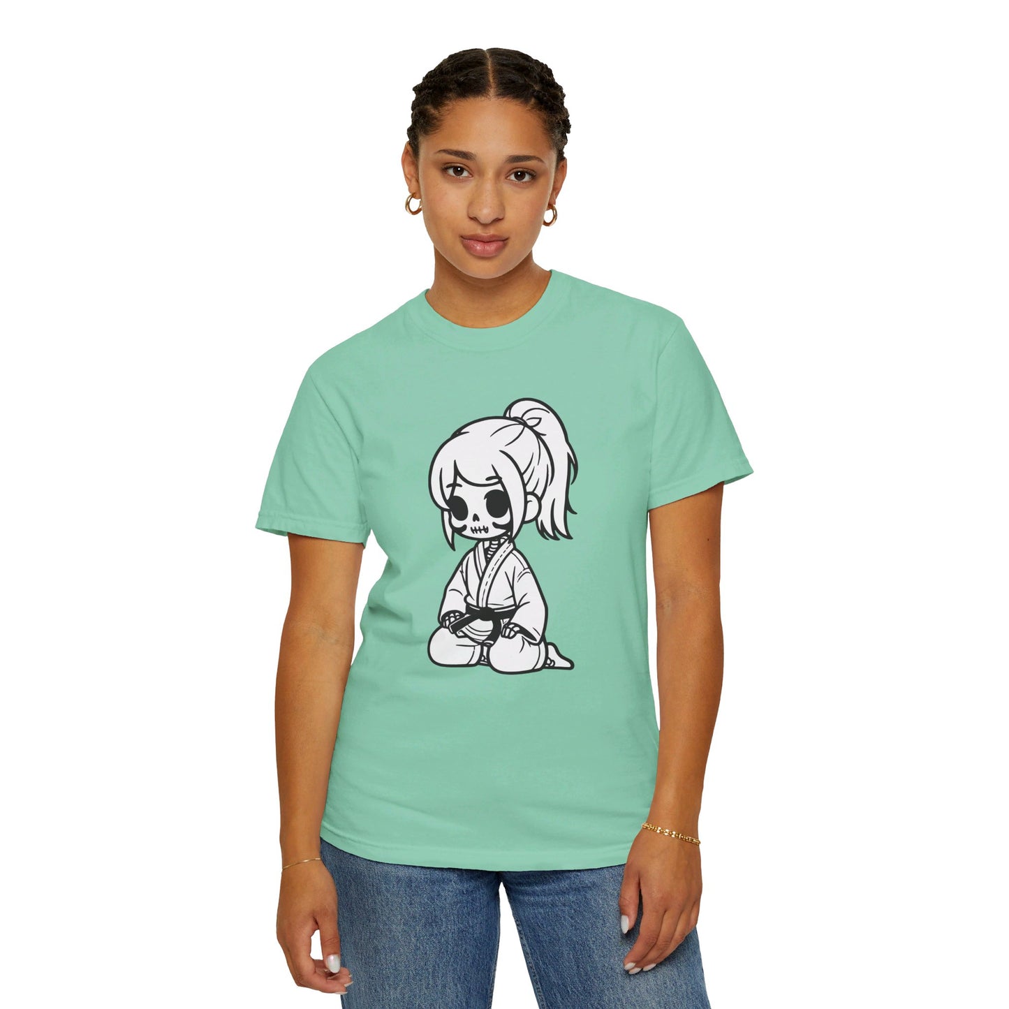 Front view of a woman wearing an Island Reef colored cotton t-shirt, with a design of a skeleton girl wearing a jiu jitsu gi printed on the front of the shirt.