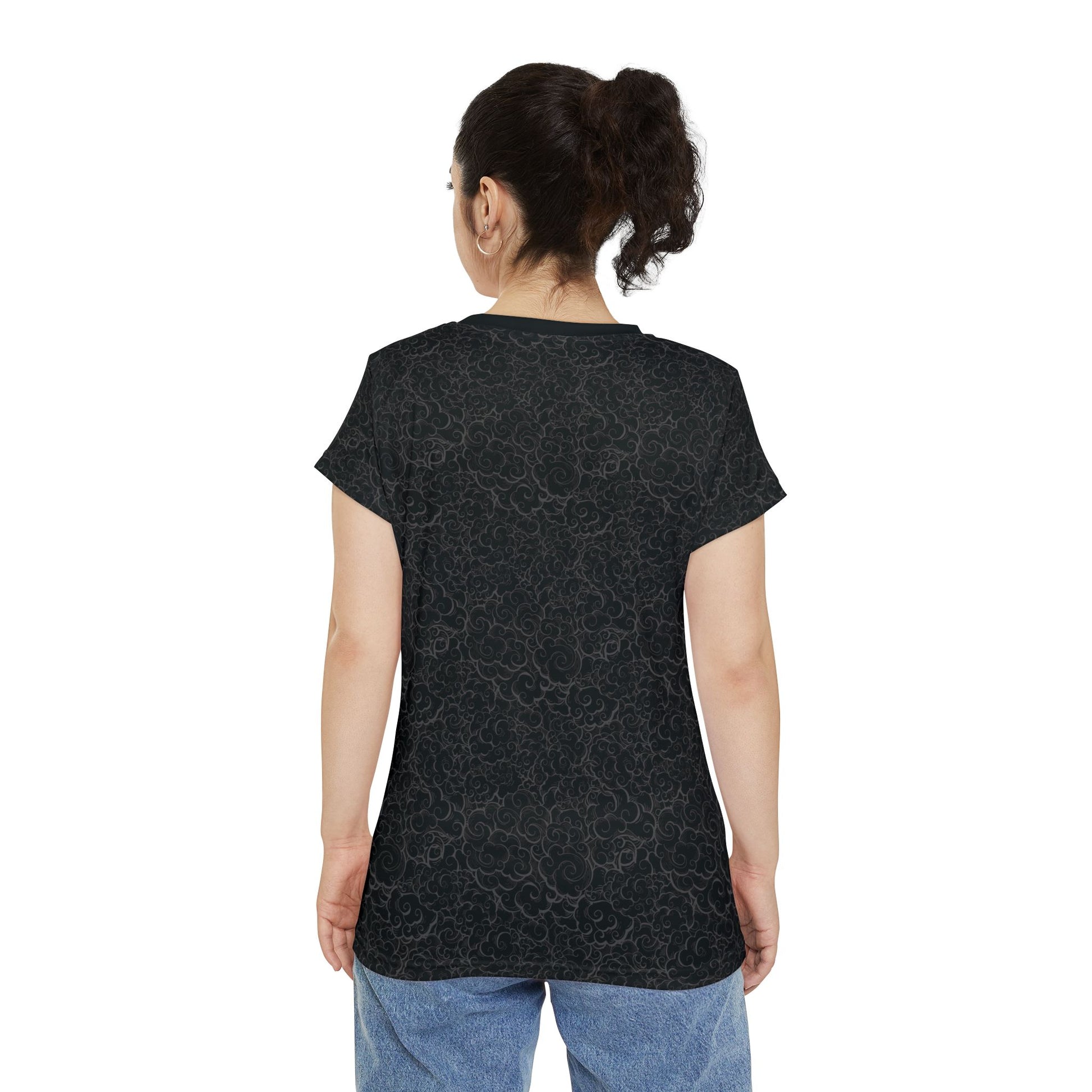 Back view of a woman wearing a black, polyester blend women's t-shirt with a light background pattern.