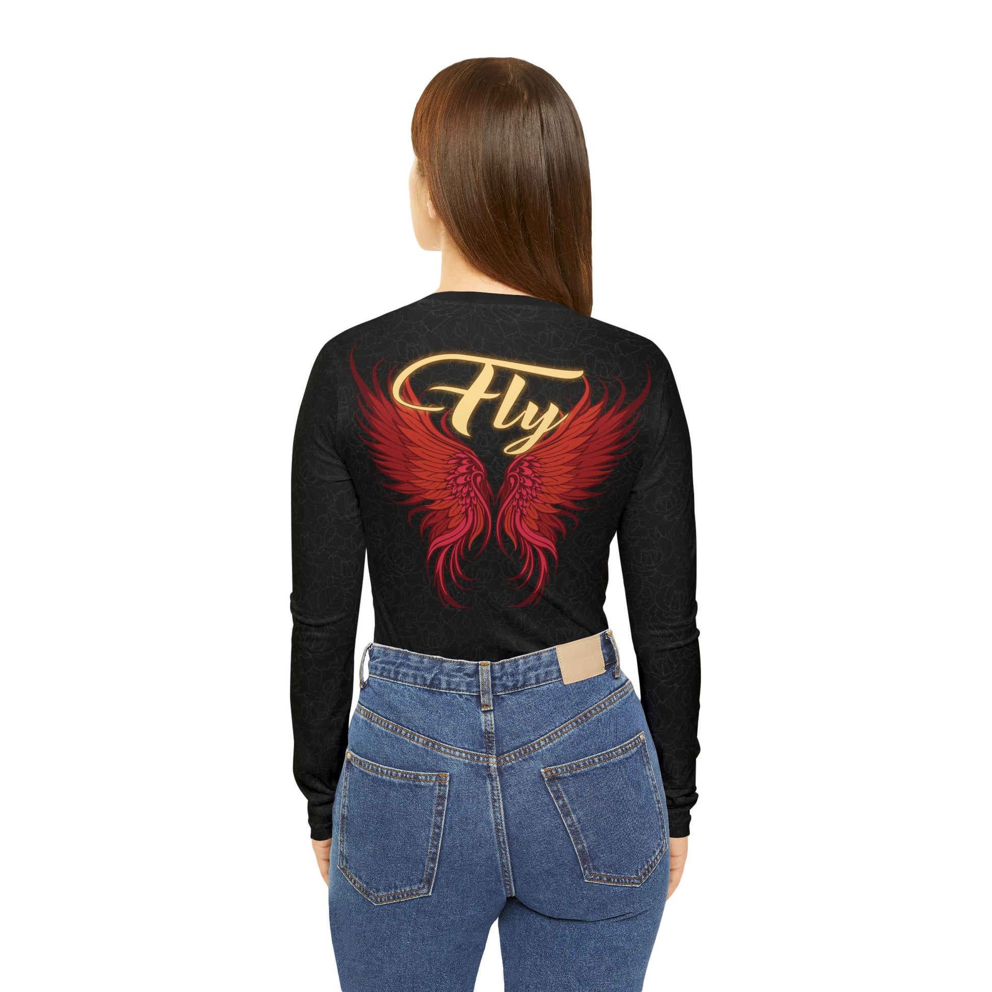 Back view of a woman wearing a black, patterned long sleeve v-neck shirt with angel wings. Above the wings is cursive text that reads "Fly".