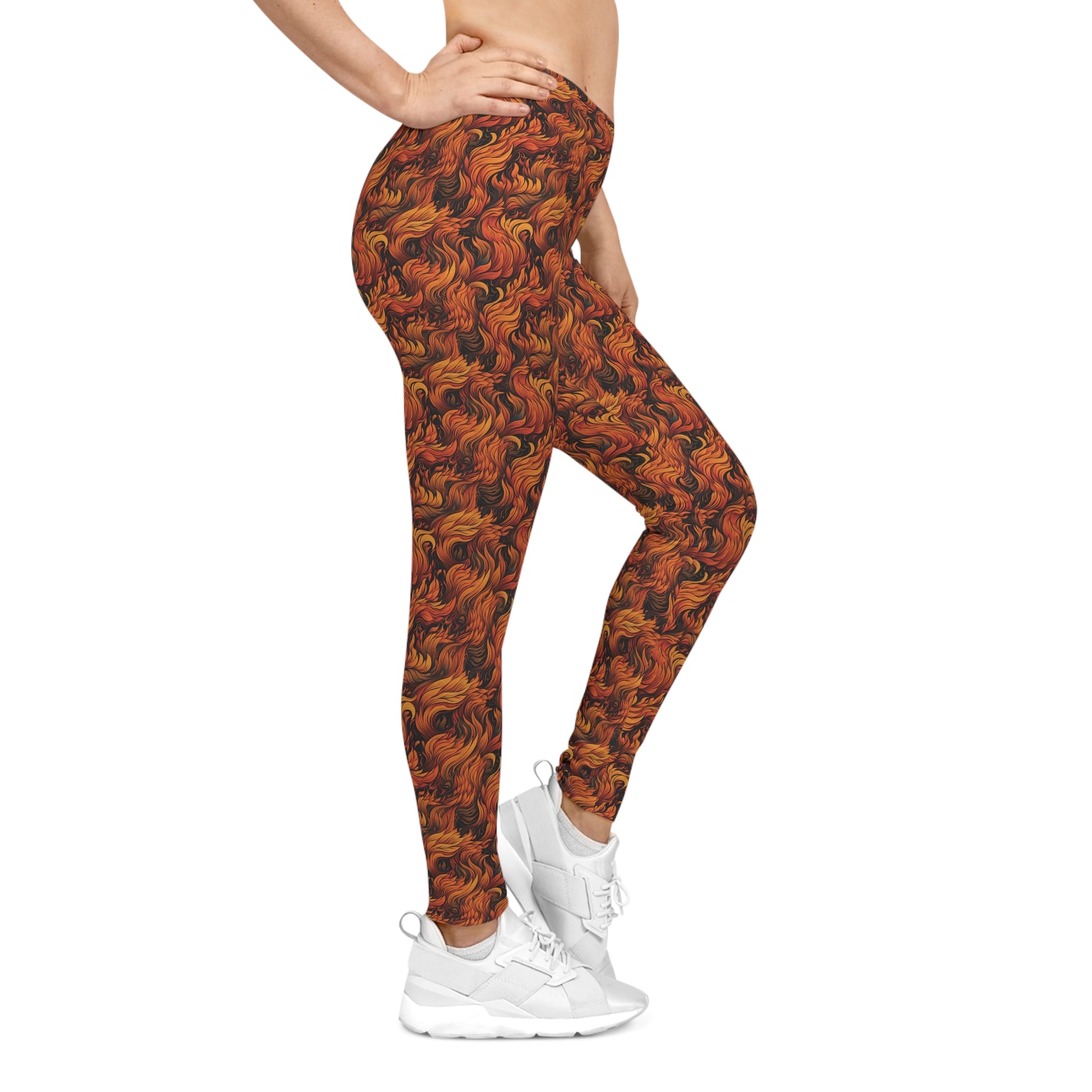 Right side view of a woman wearing low rise leggings with a fire and flames all-over-print.