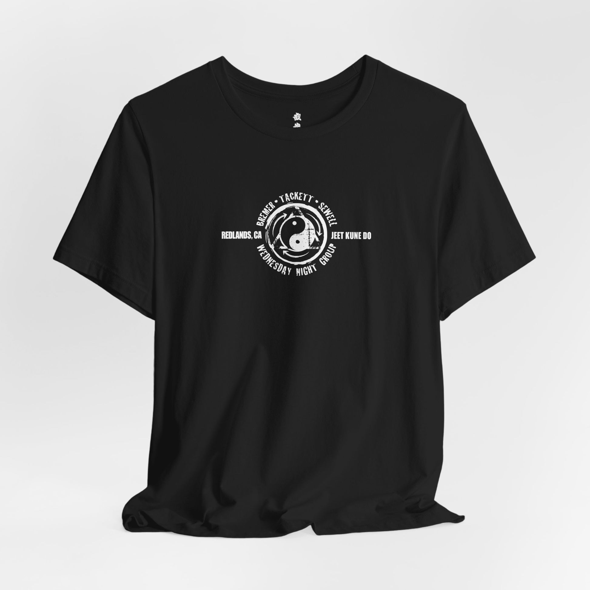 Alternate front view of a black cotton t-shirt, with the JKD Wednesday Night Group logo on the chest.