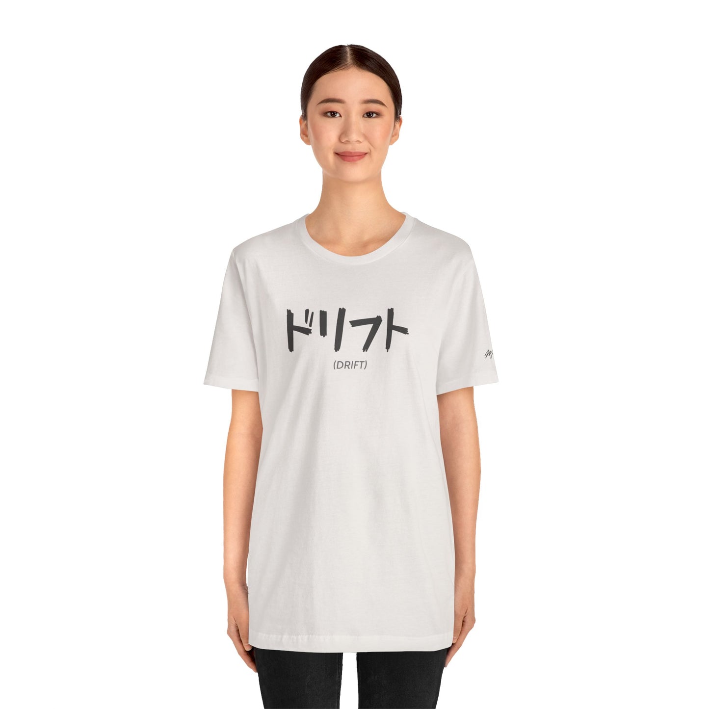 Woman wearing an off-white t-shirt with text printed on the chest that spells Drift in Japanese.