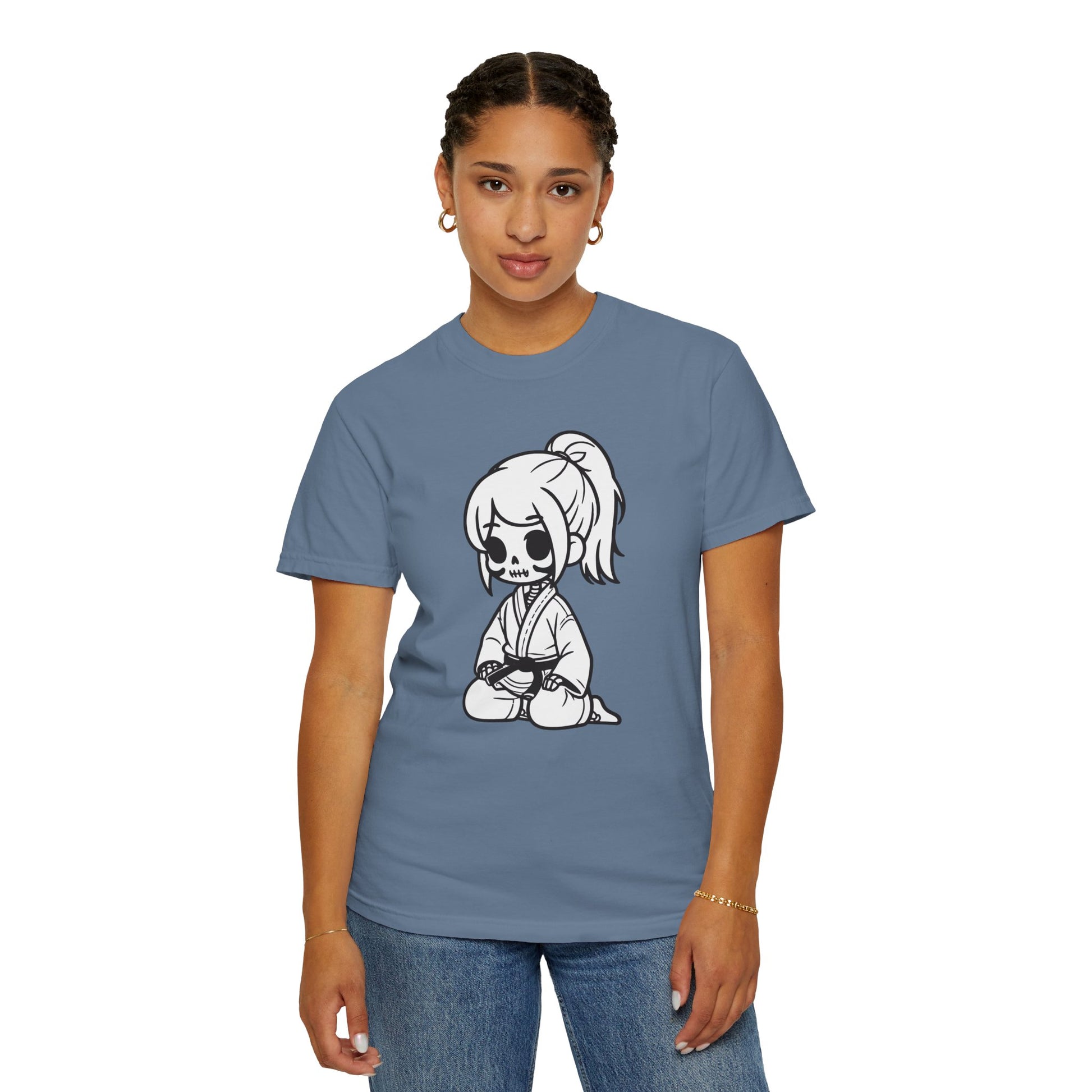 Front view of a woman wearing a Blue Jean colored cotton t-shirt, with a design of a skeleton girl wearing a jiu jitsu gi printed on the front of the shirt.