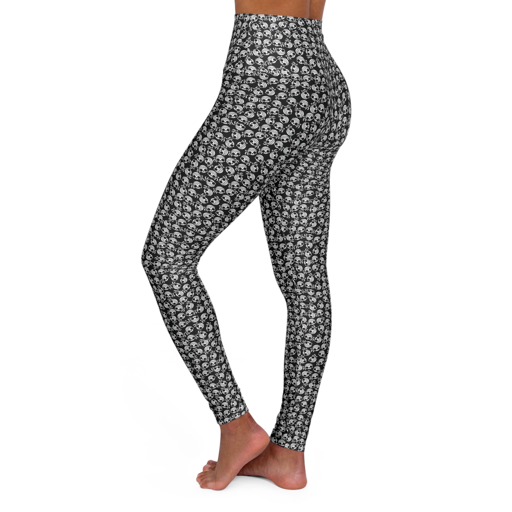 Left side view of a woman wearing skull-patterned, high-waist yoga leggings.