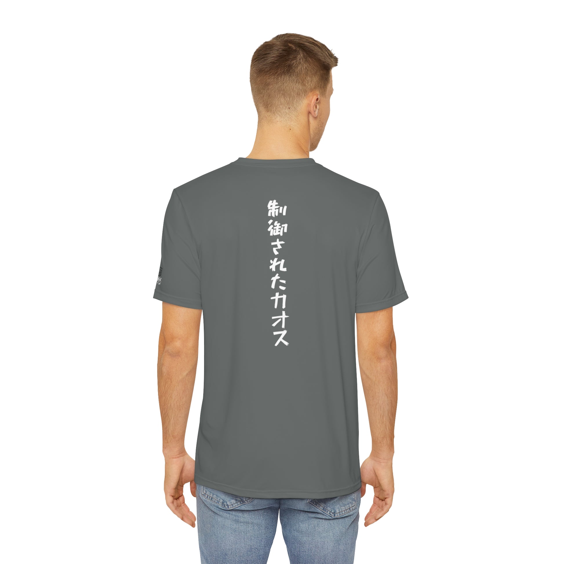 Back view of a man wearing a dark gray polyester t-shirt, with the words "Controlled Chaos" written vertically down the middle of the shirt in Japanese.