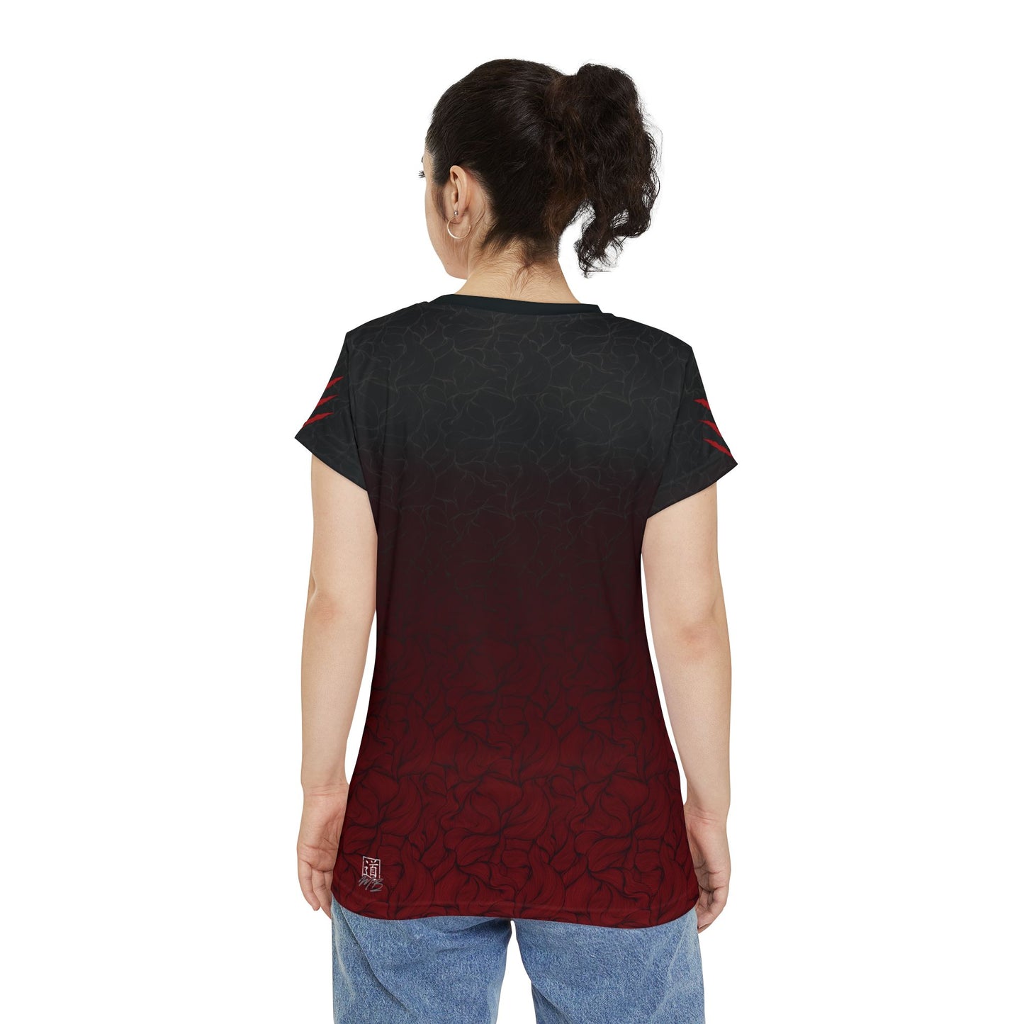 Back view of a woman wearing a black and red polyester, all over print t-shirt.