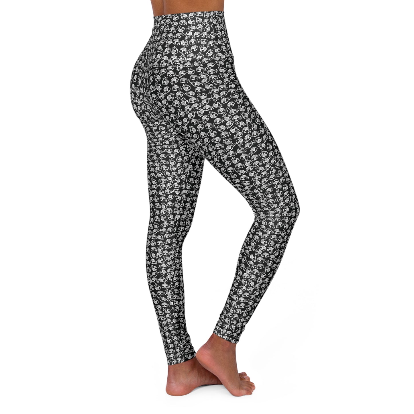 Right side view of a woman wearing skull-patterned, high-waist yoga leggings.