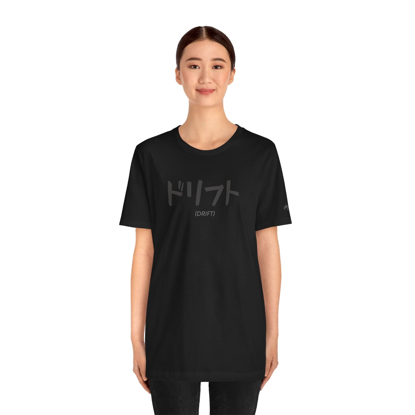 Woman wearing a black t-shirt with text printed on the chest that spells Drift in Japanese.