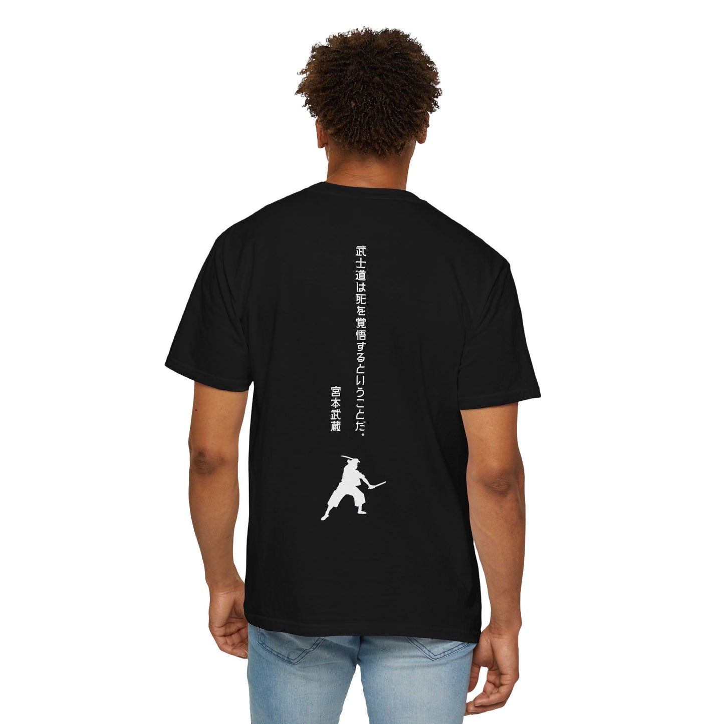 Back view of a man wearing a black cotton t-shirt, with modern Japanese text written vertically that reads, "Bushido means being prepared to die." Below the text is a silhouette image of Miyamoto Musashi wielding two swords.