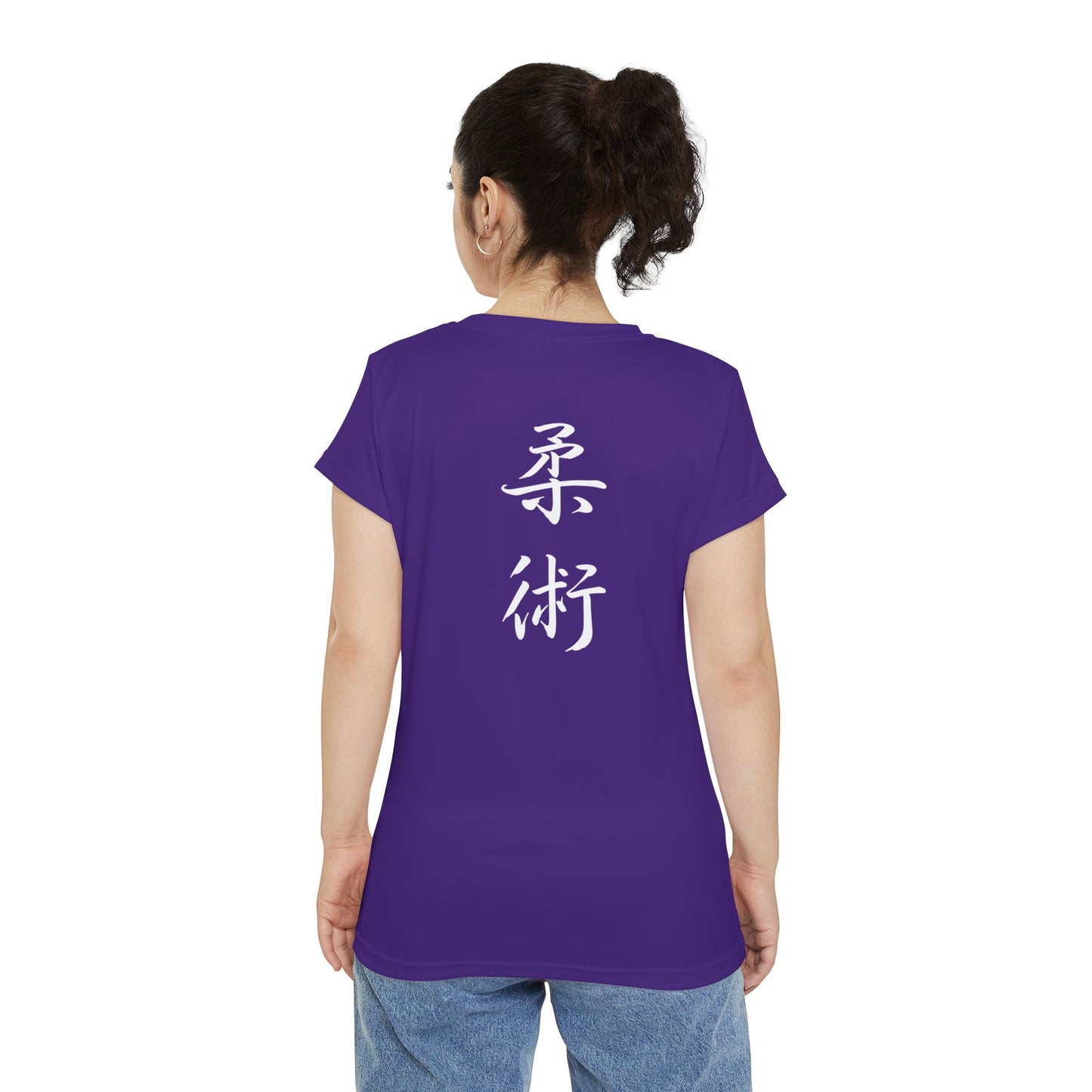 Back view of a woman wearing a purple polyester blend t-shirt, with the kanji symbols for Jiu Jitsu printed vertically down the middle of the shirt.