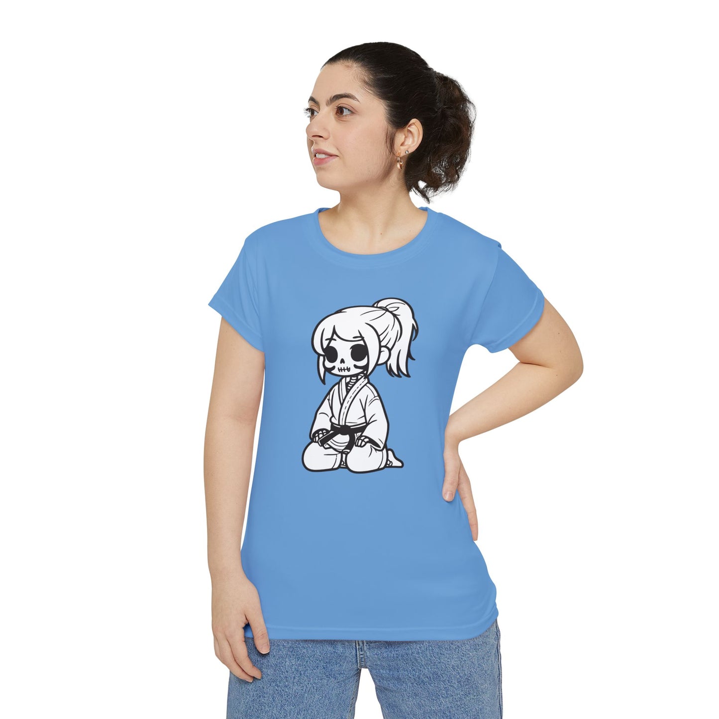 Front view of a woman wearing a light blue, polyester blend t-shirt with a design of a skeleton girl wearing a jiu jitsu gi and black belt on the front.