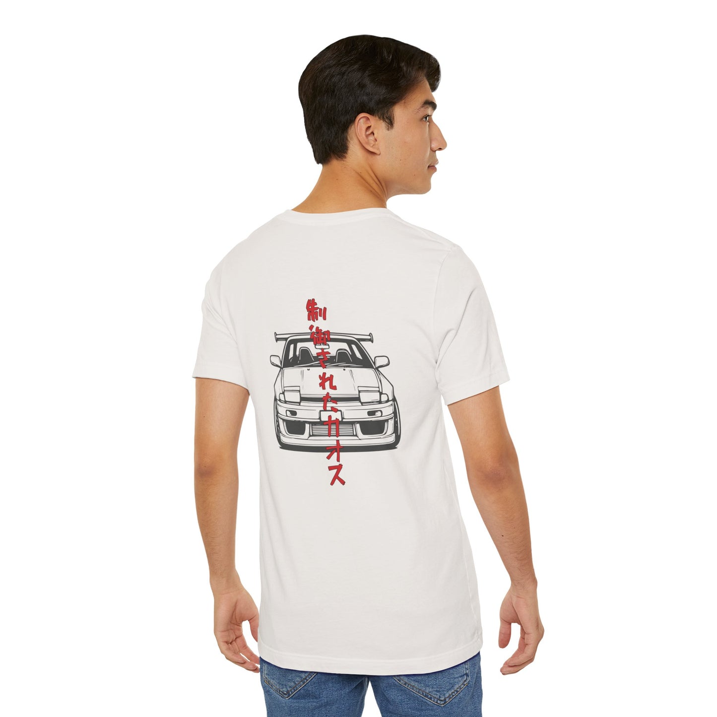 Back view of a man wearing an off-white t-shirt with an illustration of a drift car, and the words "Controlled Chaos" written vertically in Japanese characters.