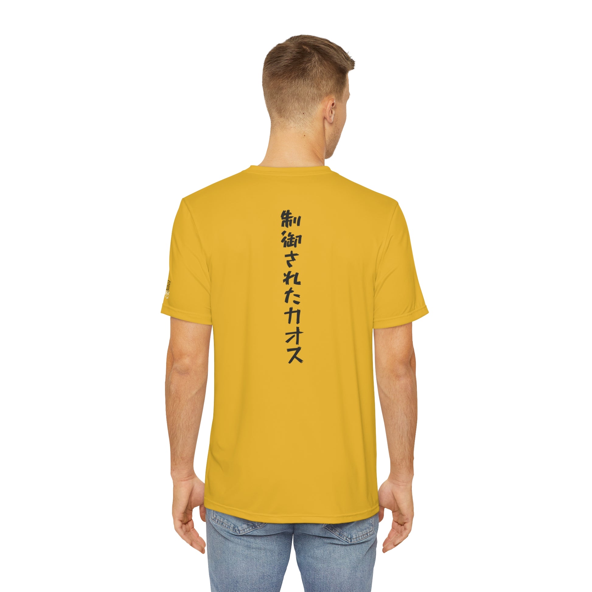 Back view of a man wearing a yellow polyester t-shirt, with the words "Controlled Chaos" written vertically down the middle of the shirt in Japanese.