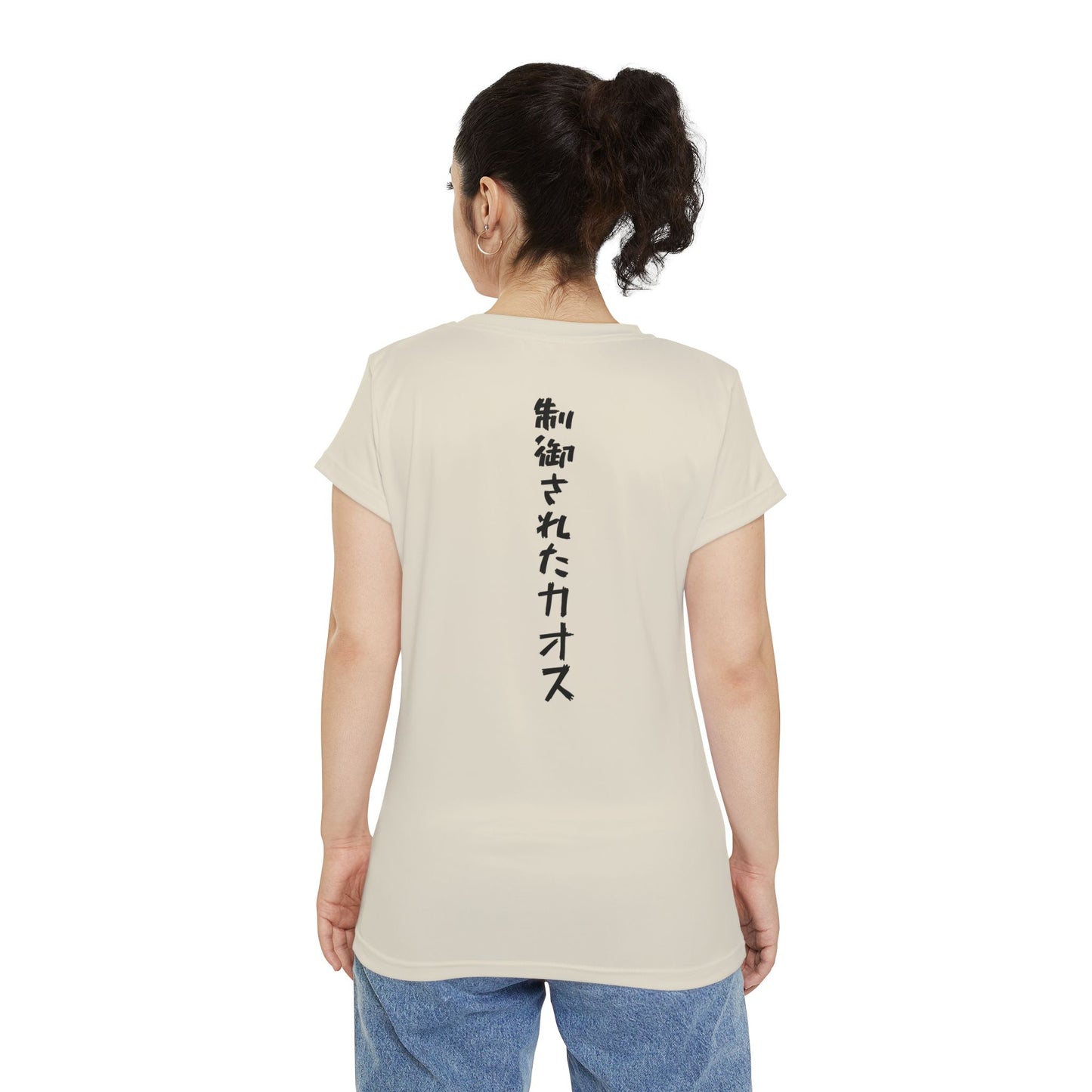 Back view of a woman wearing an off-white, polyester blend t-shirt, with the words "Controlled Chaos" written vertically down the middle of the shirt in Japanese.