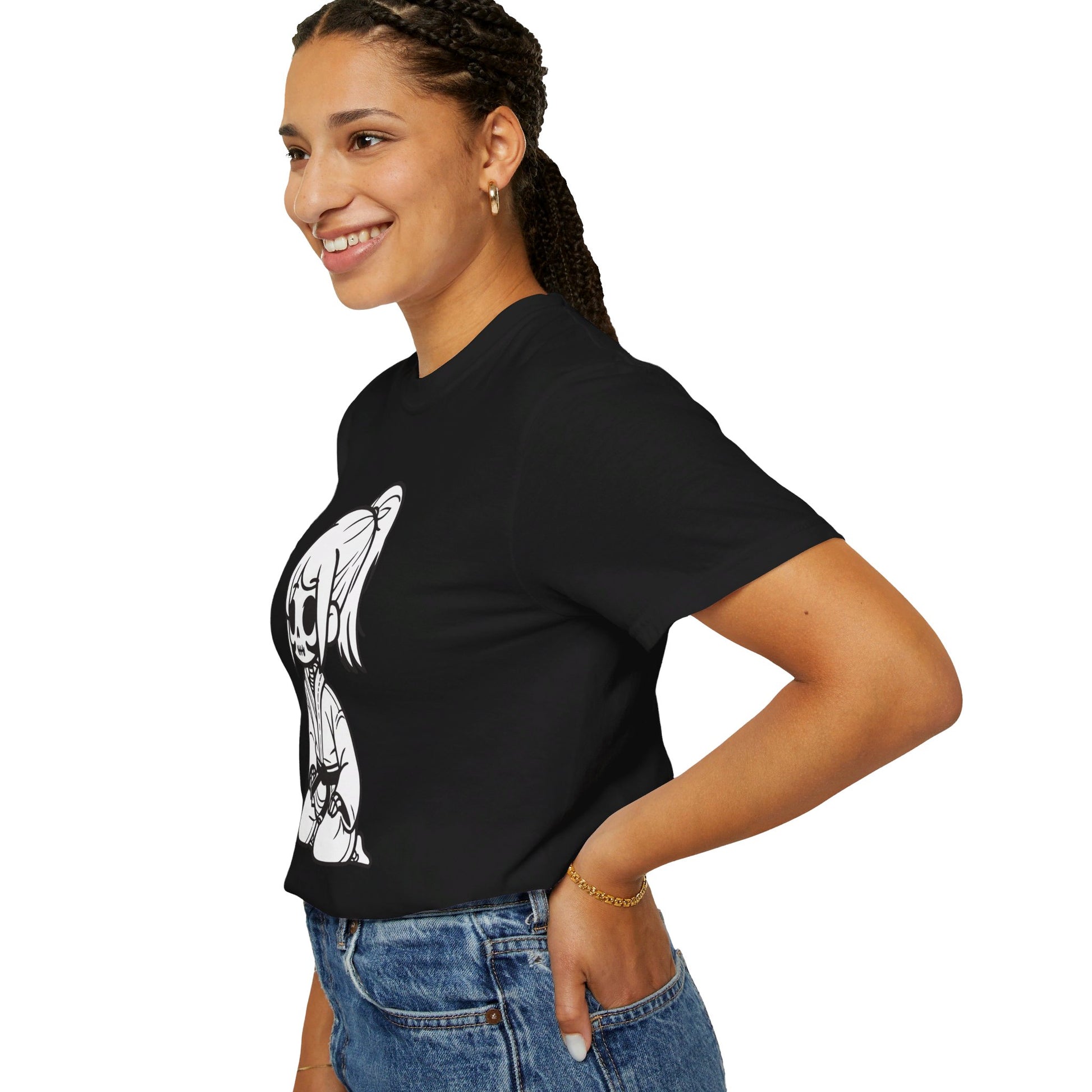 Left side view of a woman wearing a black cotton t-shirt, with a design of a skeleton girl wearing a jiu jitsu gi printed on the front of the shirt.