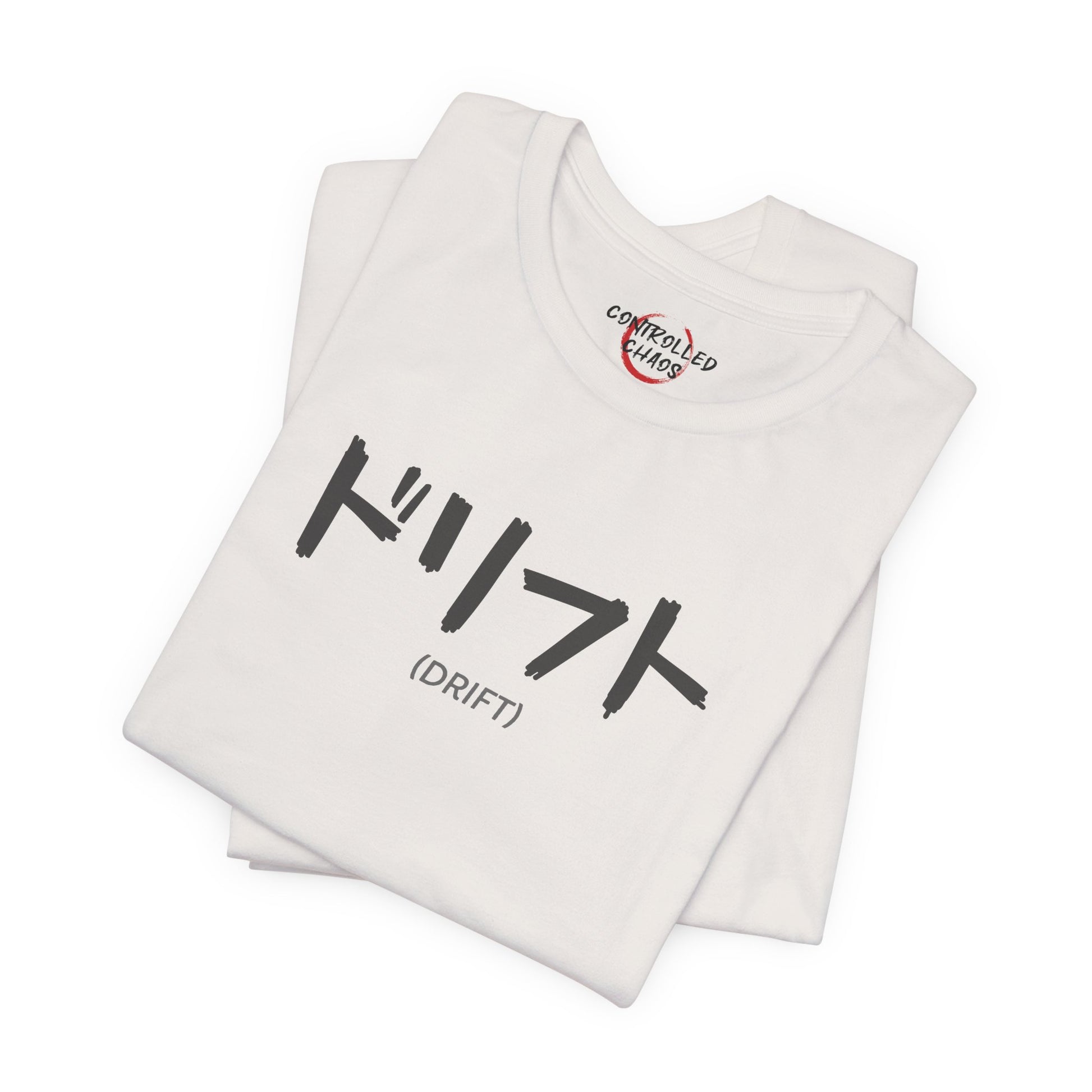 A folded, off-white t-shirt with text printed on the chest that spells Drift in Japanese.