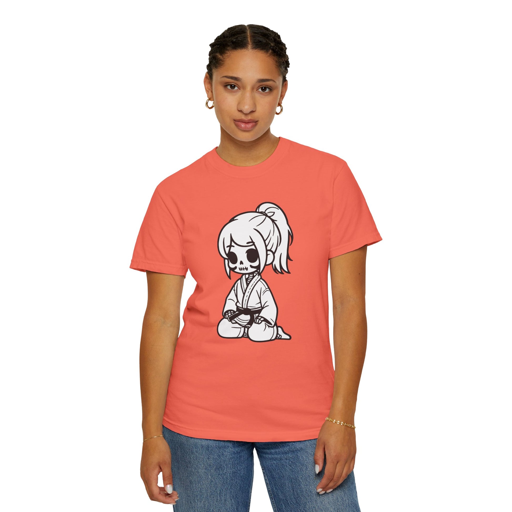 Front view of a woman wearing a Bright Salmon colored cotton t-shirt, with a design of a skeleton girl wearing a jiu jitsu gi printed on the front of the shirt.