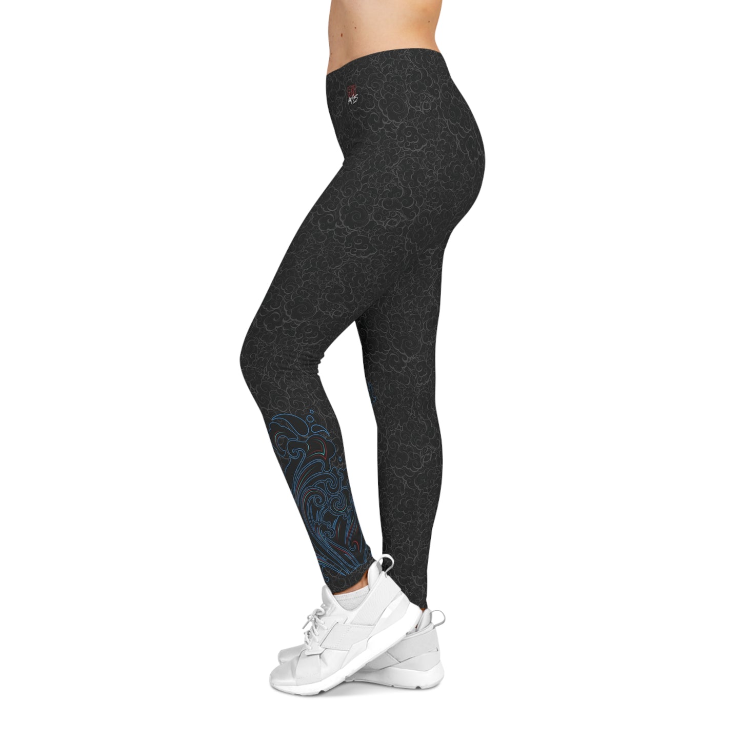 Left side view of black, patterned low-rise leggings, with an abstract design on the left calf area.