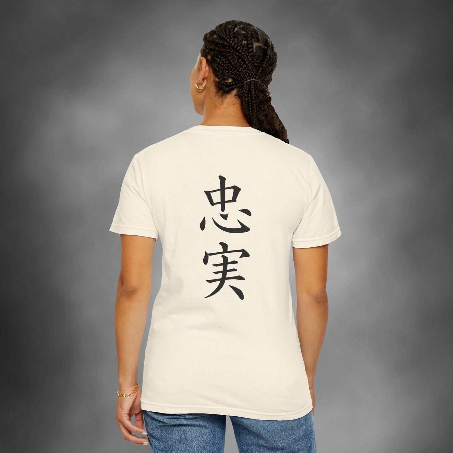 Back view of a woman wearing an ivory colored cotton t-shirt with the kanji for "Loyal" printed vertically down the middle.