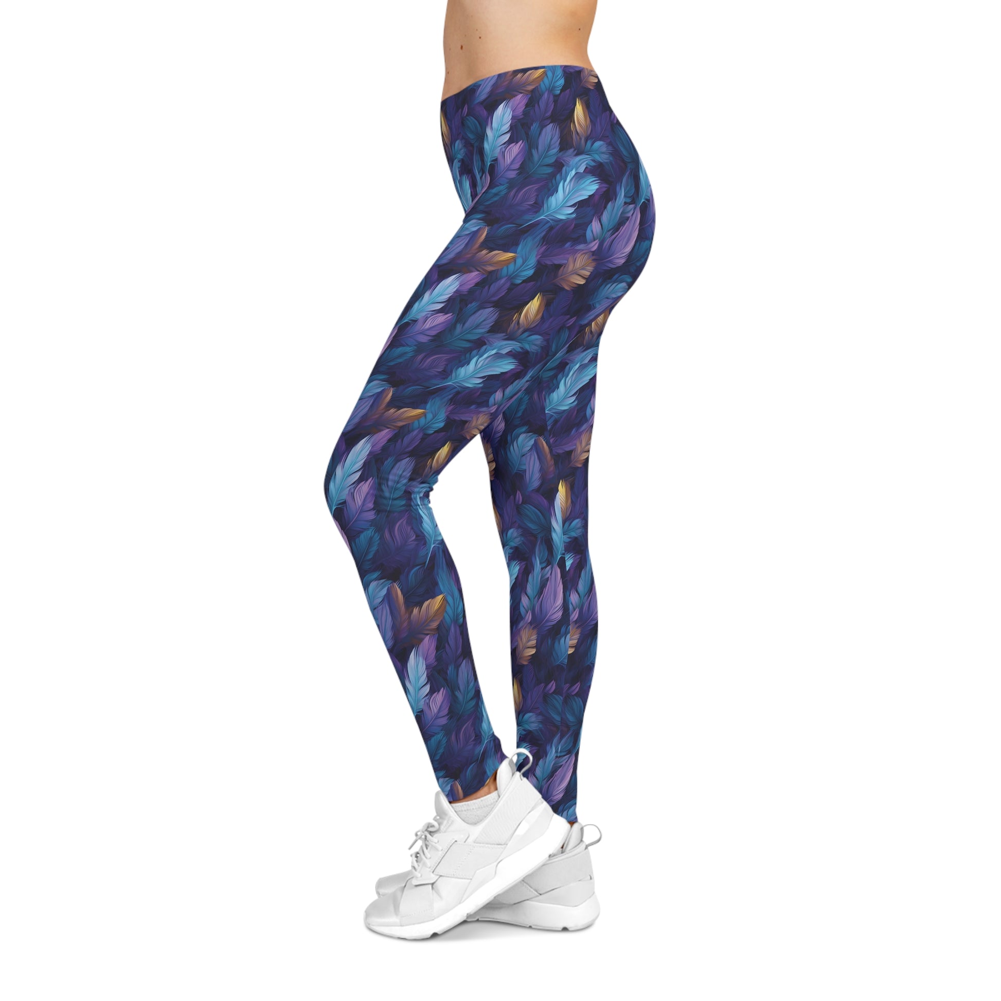 Left side view of a woman wearing low rise leggings with a blue and purple feather print.