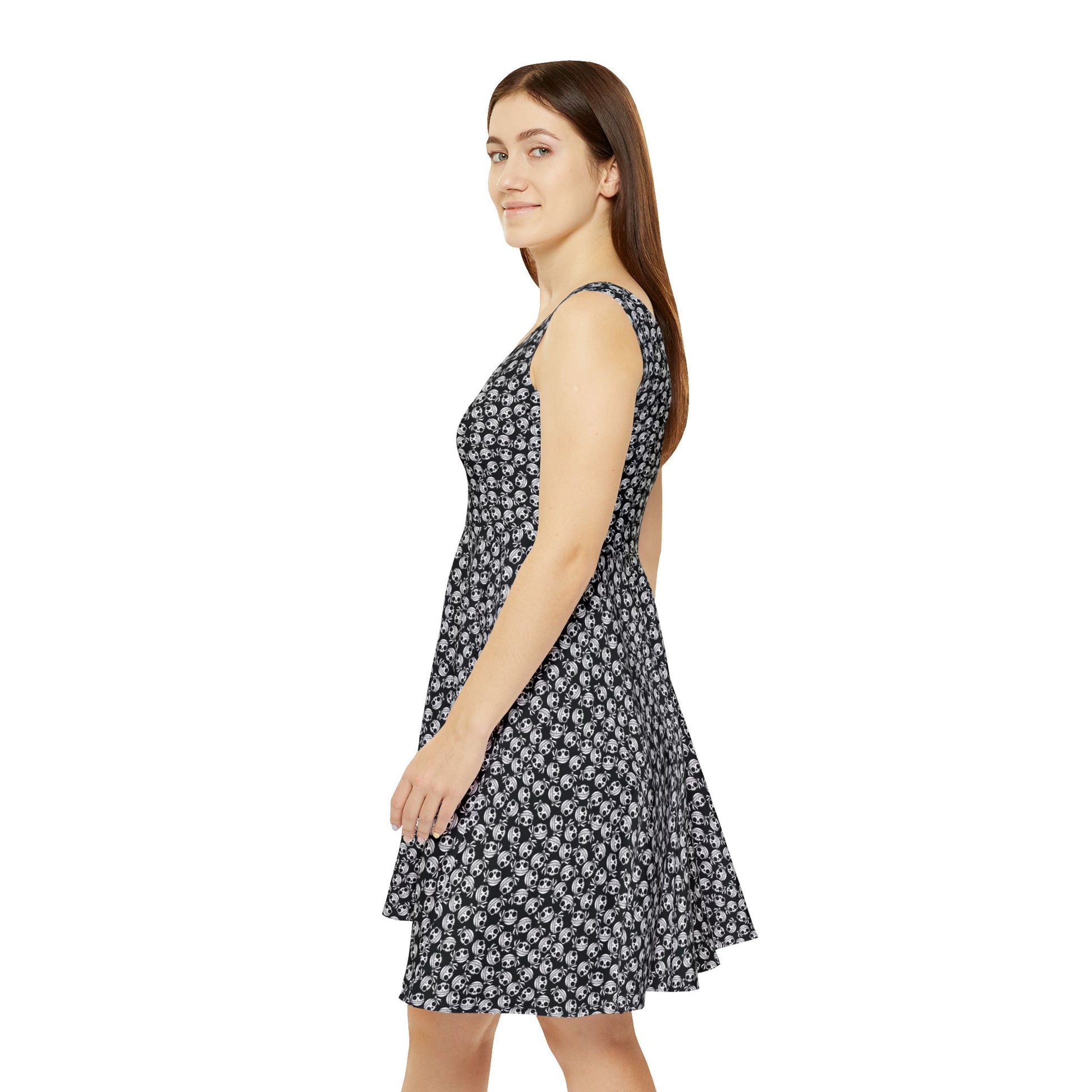 Left side view of a woman wearing a skull-patterned, polyester/spandex blend skater dress.