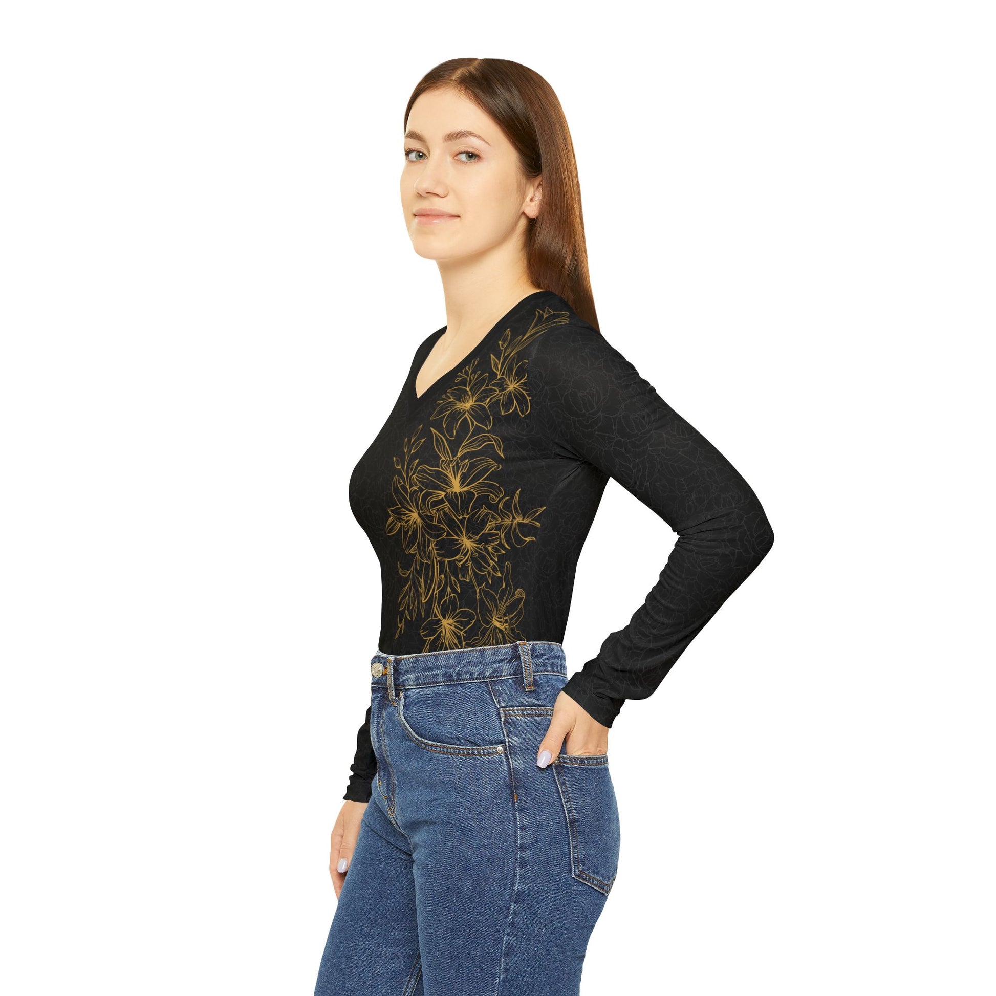 Left side view of a woman wearing a black, patterned long sleeve v-neck shirt with a gold, floral print covering the left size of the shirt.