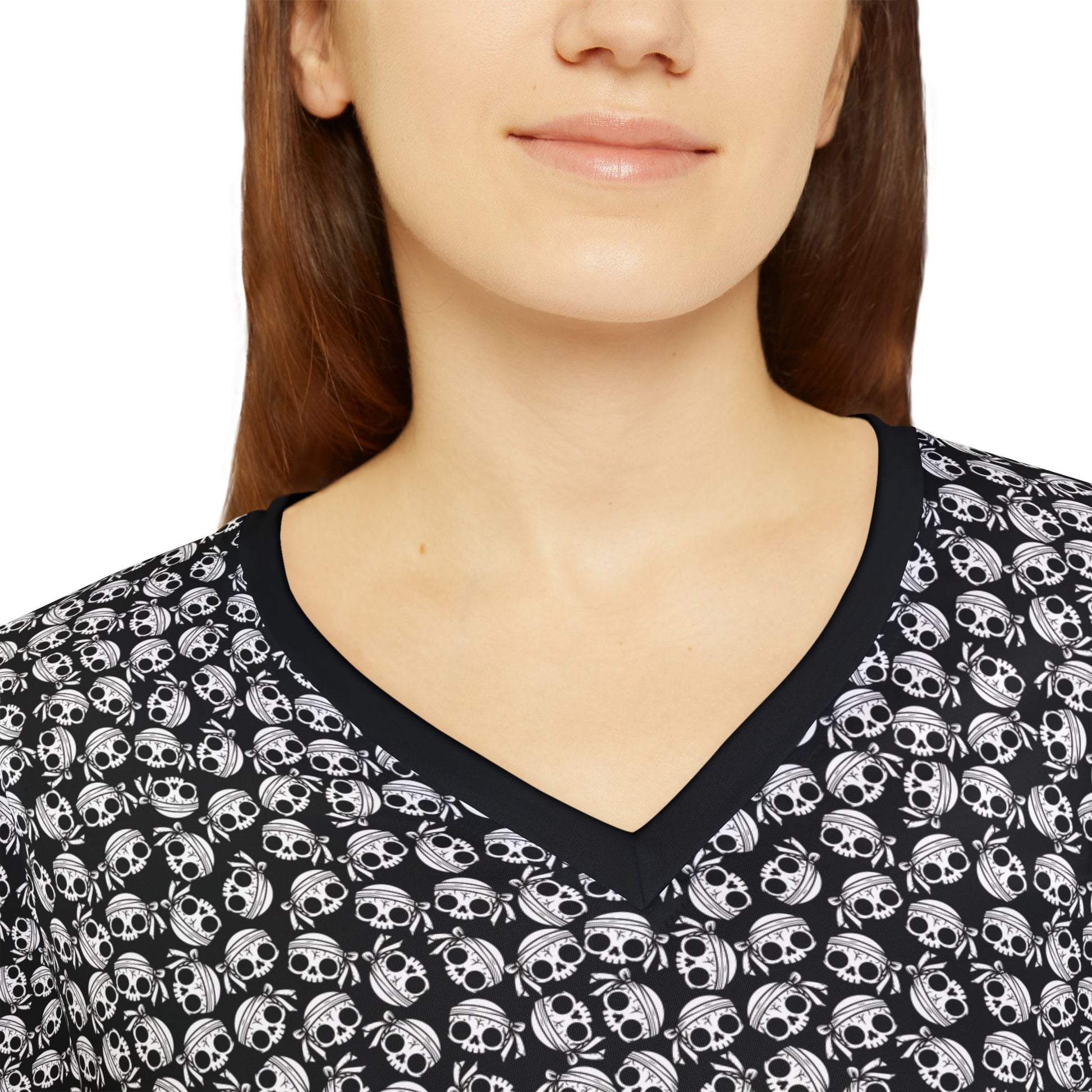 Close up view of a woman wearing a skull-patterned, long sleeve v-neck shirt.