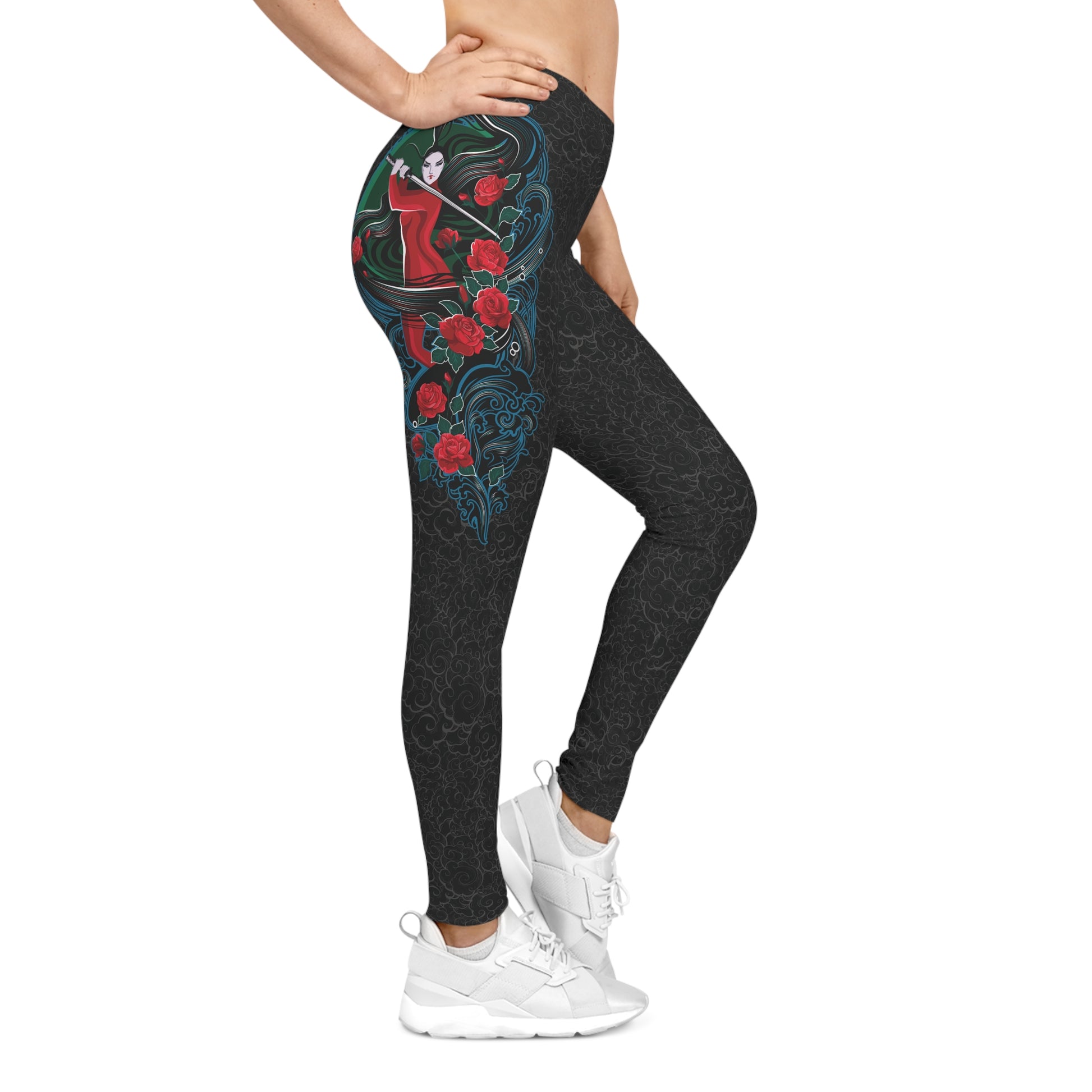 Right side view of black, low-rise casual leggings with a light background pattern. Printed on the right, upper hip area is an illustration of a female warrior holding a katana sword.