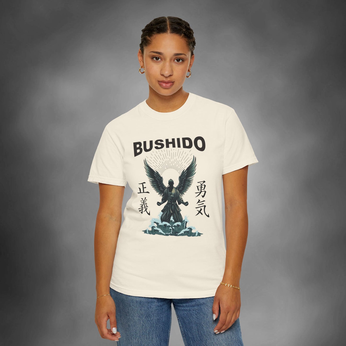 Woman wearing an ivory colored cotton t-shirt, with an illustration of a martial artist with angel wings. The text above the design reads "Bushido", and the kanji on the left and right sides are translated to English as "Justice" and "Courage".