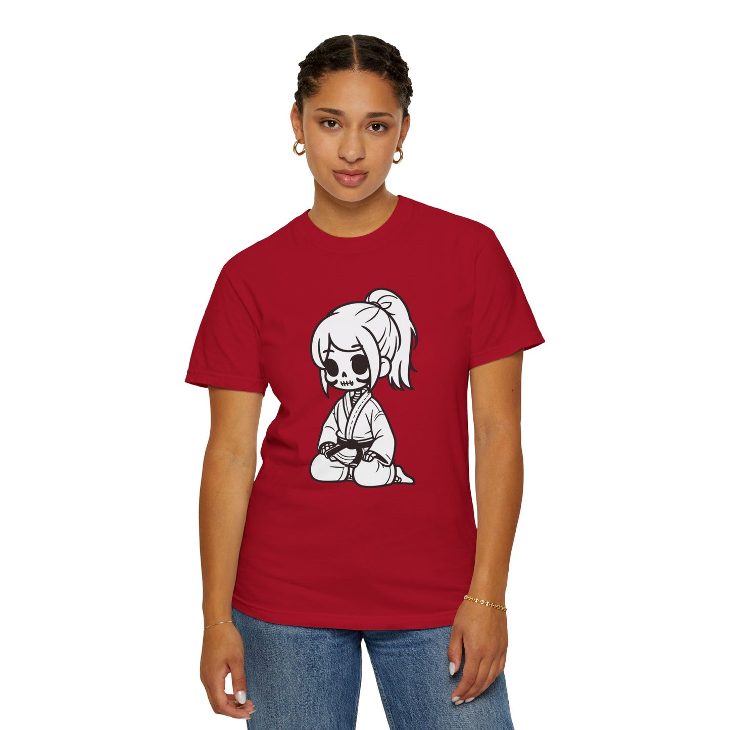 Front view of a woman wearing a red cotton t-shirt, with a design of a skeleton girl wearing a jiu jitsu gi printed on the front of the shirt.