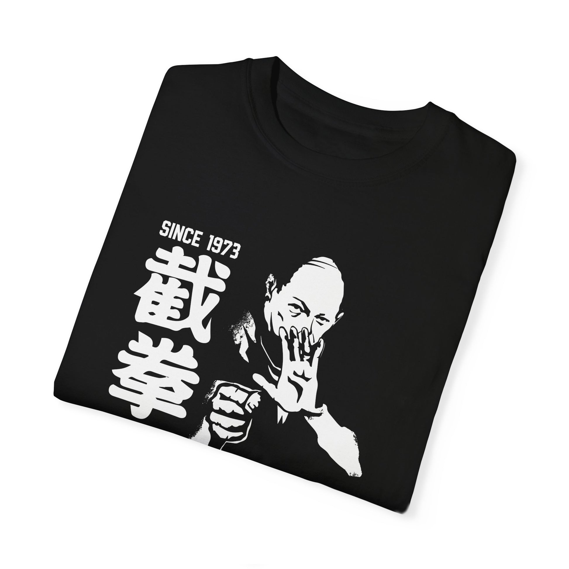 A folded, black cotton t-shirt with an illustration of martial arts instructor Tim Tackett on the front.