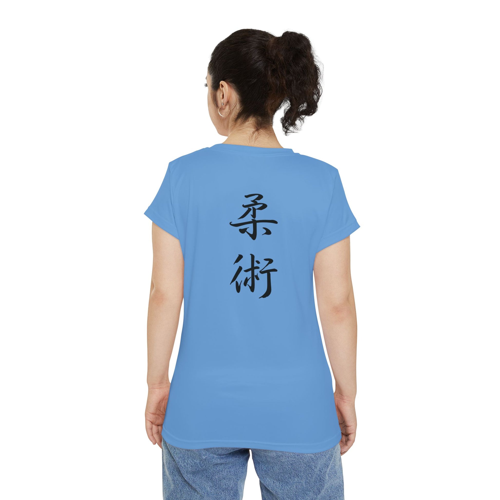 Back view of a woman wearing a light blue, polyester blend t-shirt with the kanji symbols for Jiu Jitsu printed vertically down the middle of the shirt.