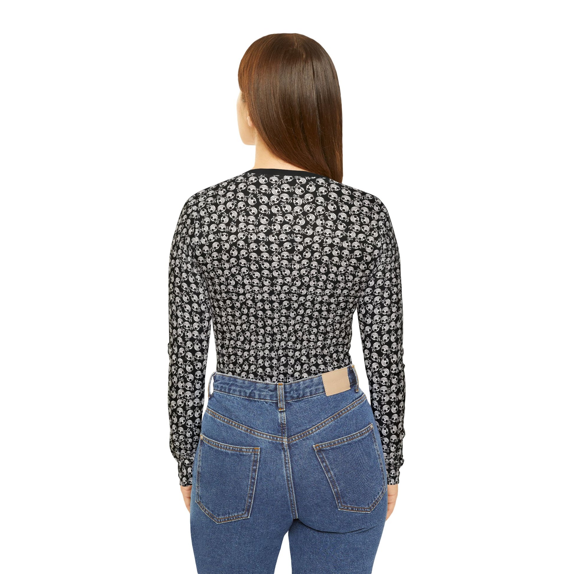 Back view of a woman wearing a skull-patterned, polyester blend, long sleeve Women's v-neck shirt.