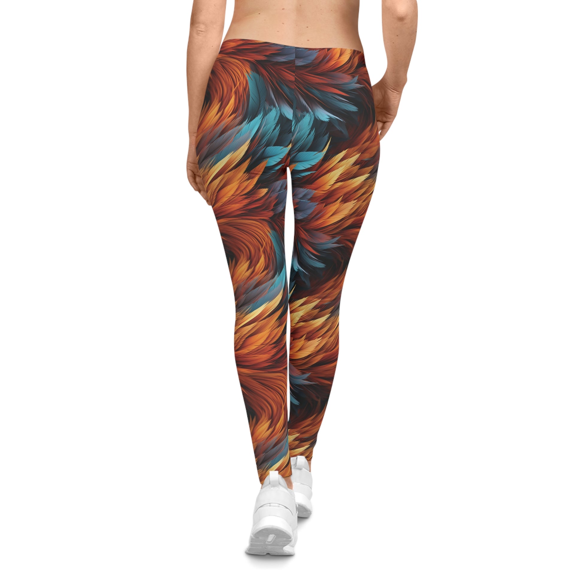 Back view of a woman wearing aqua and orange colored, feather print low rise leggings.