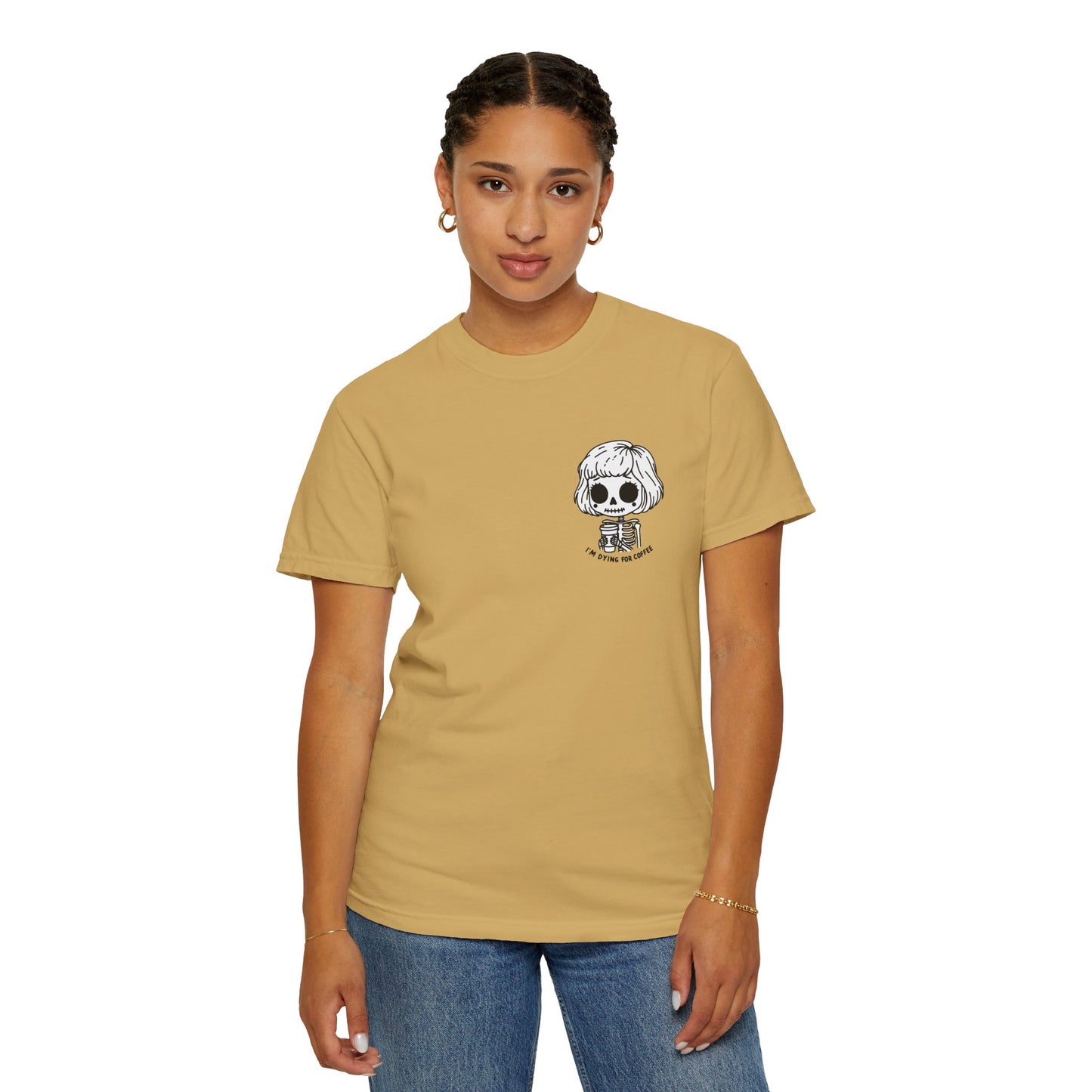 Alternate view of a woman wearing a Mustard colored t-shirt with a design of a skeleton girl holding a cup of coffee printed on the front. Written underneath the design is the text, "I'm dying for coffee". The design is placed on the left chest area of the t-shirt.