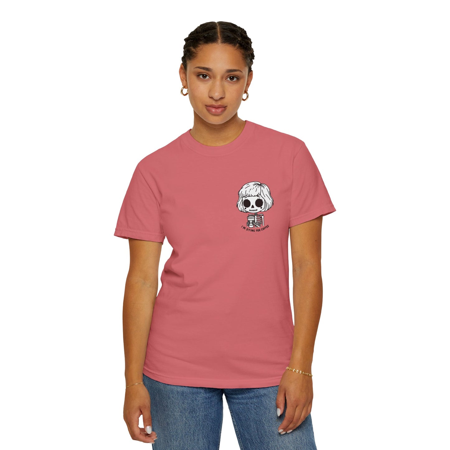 Alternate view of a woman wearing a Watermelon colored t-shirt with a design of a skeleton girl holding a cup of coffee printed on the front. Written underneath the design is the text, "I'm dying for coffee". The design is placed on the left chest area of the t-shirt.