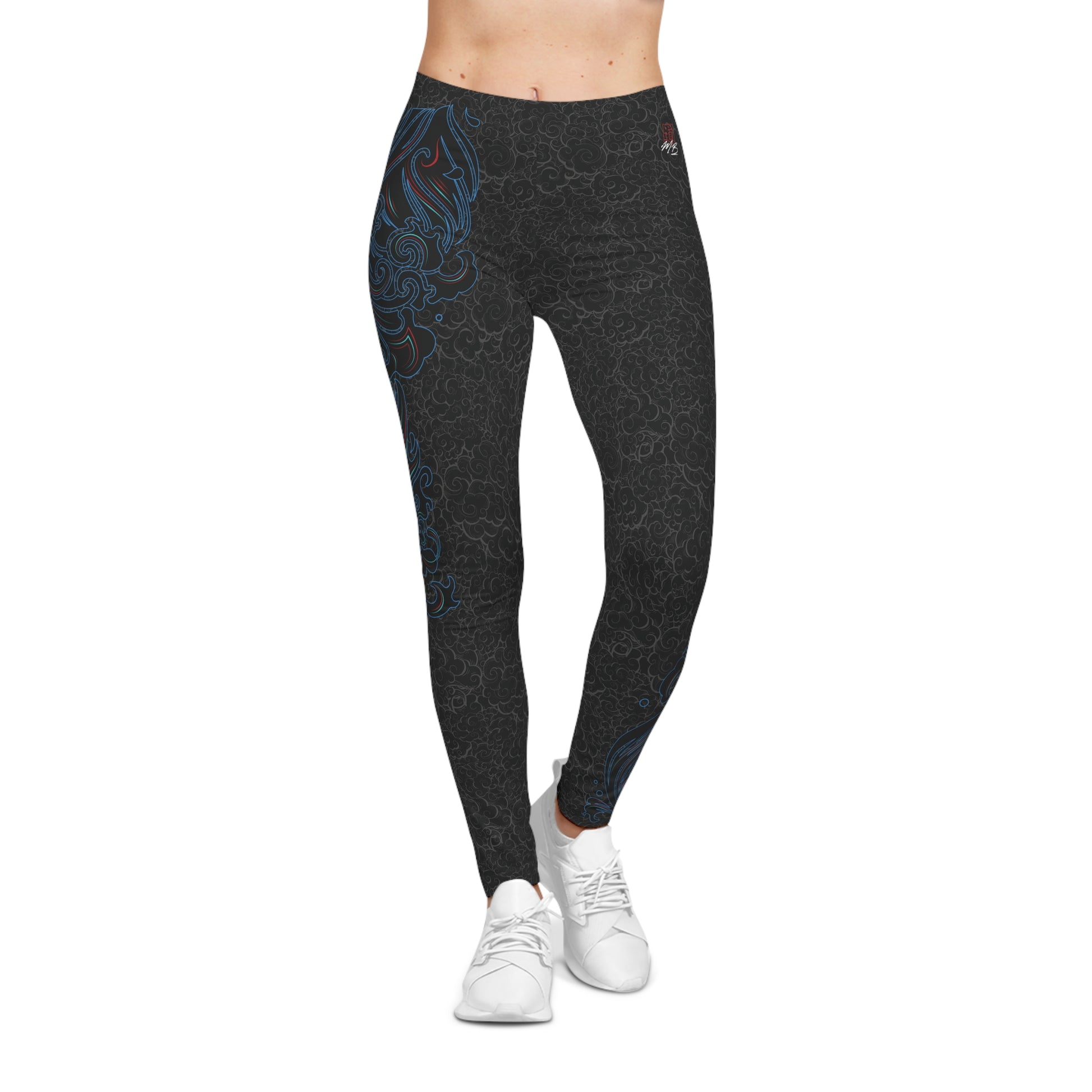 Front view of black, patterned low-rise leggings, with a large, abstract design on the upper right hip.