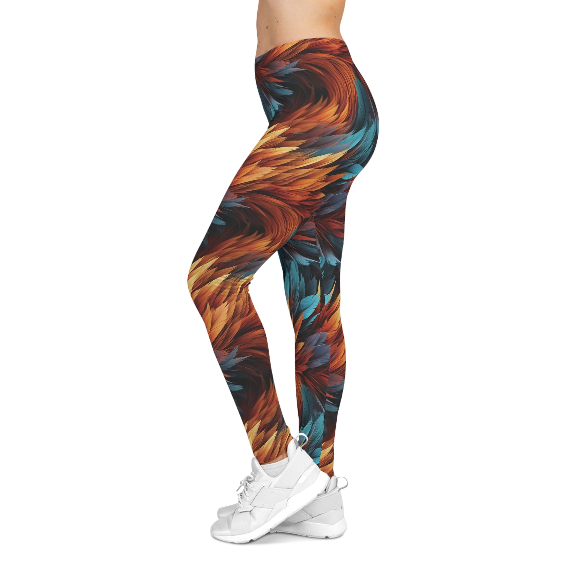 Left side view of a woman wearing aqua and orange colored, feather print low rise leggings.