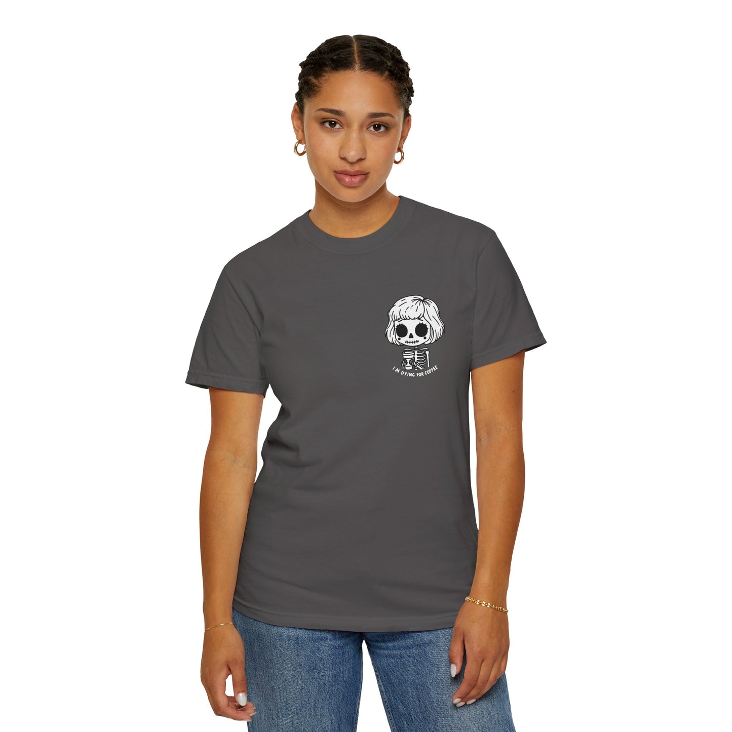 Alternate view of a woman wearing a Pepper colored t-shirt with a design of a skeleton girl holding a cup of coffee printed on the front. Written underneath the design is the text, "I'm dying for coffee". The design is placed on the left chest area of the t-shirt.