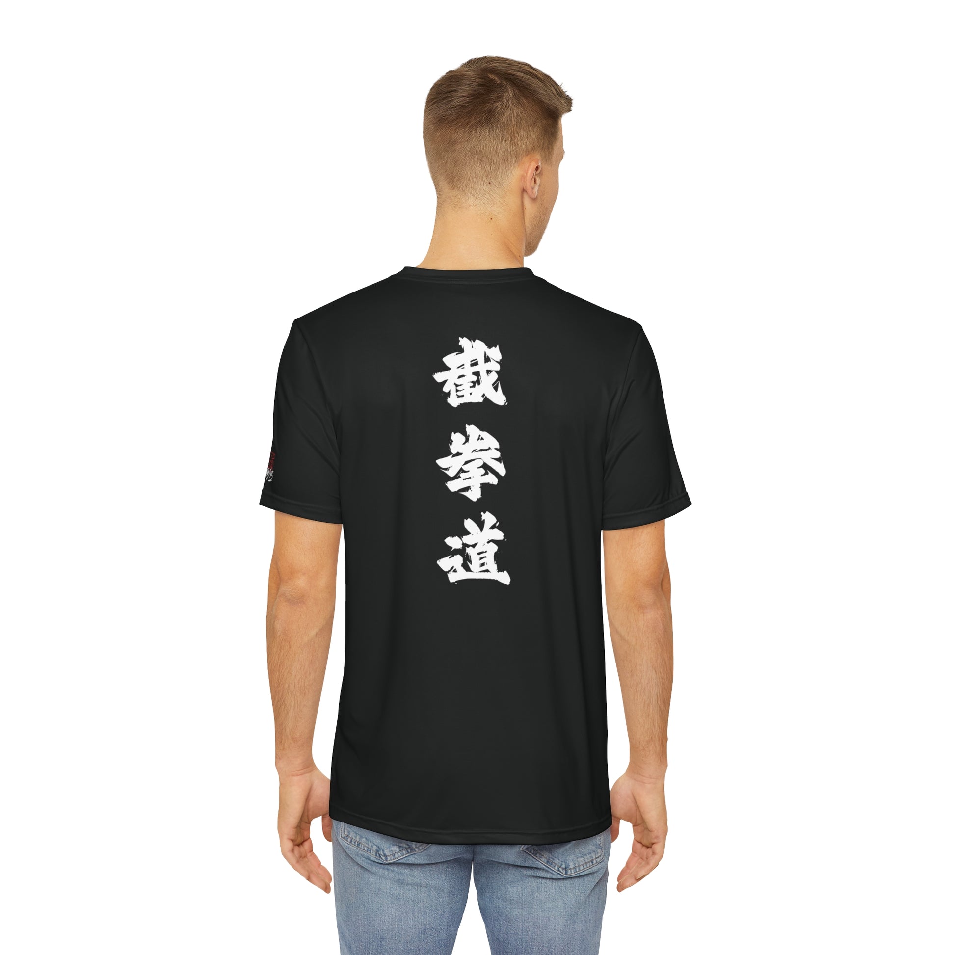 Back view of a man wearing a black t-shirt, with the Chinese characters for Jeet Kune Do placed vertically down the middle of the shirt.