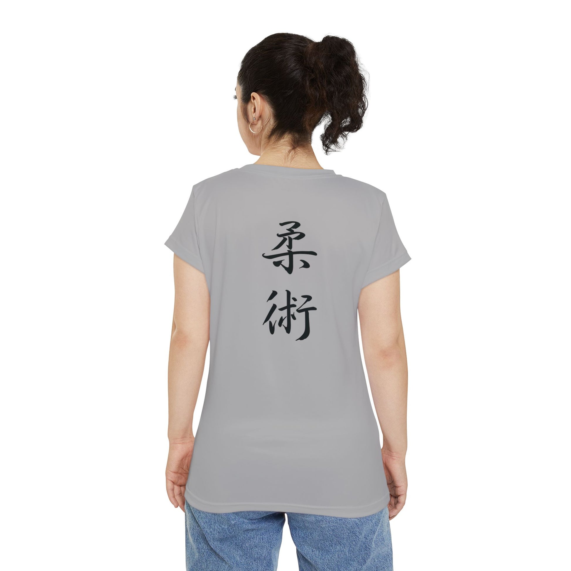 Back view of a woman wearing a light gray, polyester blend t-shirt with the kanji symbols for Jiu Jitsu printed vertically down the middle of the shirt.