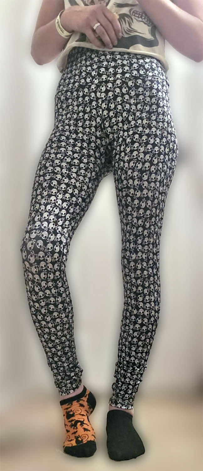 Front view of a woman wearing skull-patterned, high-waist yoga leggings.