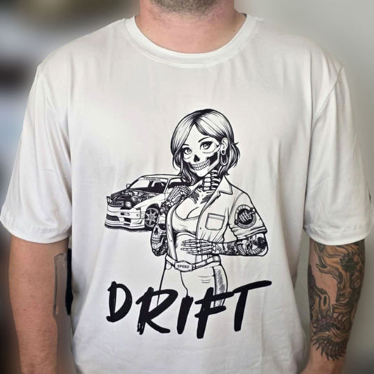 Man wearing an off-white t-shirt with a design of a female skeleton dressed as a mechanic. The mechanic is standing next to her car with the word "Drift" written underneath.